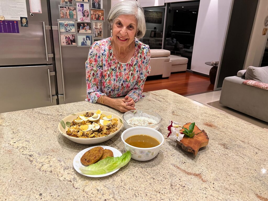 A photograph of Gooloo with food, one of the contributors to the family cookbook.